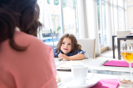 Child having breakfast with her mother and fatherの写真素材