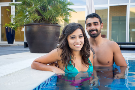 Beautiful couple having fun in swimming pool