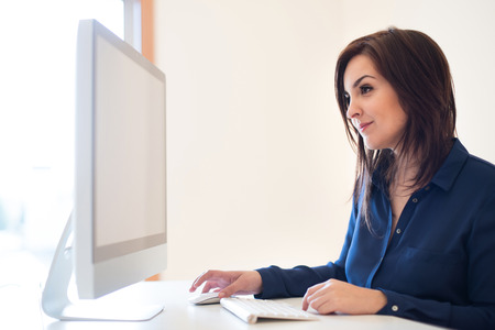Woman working with computer on her desk