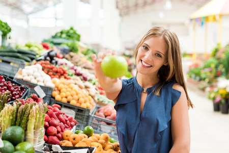 Blonde woman shopping organic veggies and fruitsの写真素材