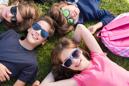 Group of little kids lying on grass