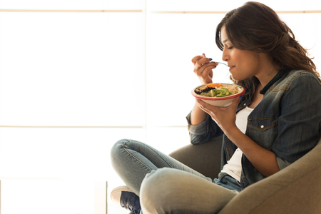 Woman eating a healthy bowl of superfoodsの写真素材