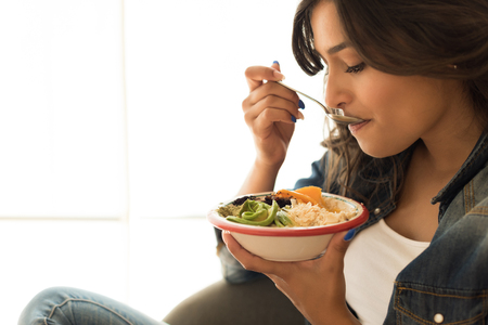 Woman eating a healthy bowl of superfoodsの写真素材