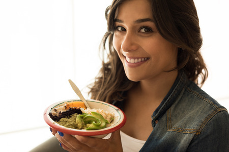 Woman eating a vegan bowl of superfoodsの写真素材