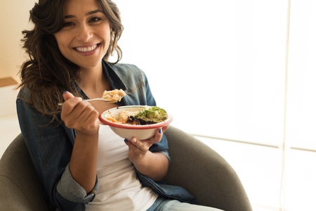 Woman eating a vegan bowl of superfoodsの写真素材