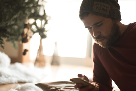 Man using a vaper and smartphone - Winter and Christmas Seasonの写真素材