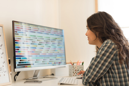 Young woman picking colors for next designの写真素材