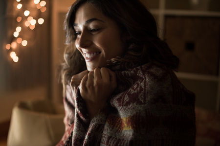 Young woman having a warm christmas timeの写真素材