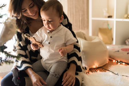 Mother and toddler decorating the Christmas tree.の写真素材