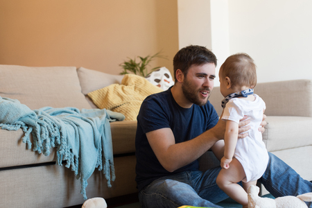 Modern father playing with little baby boyの写真素材