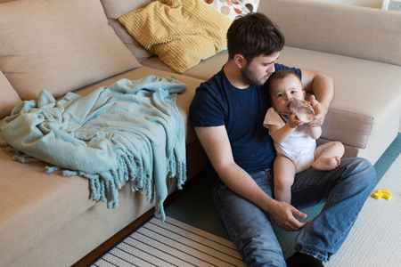Modern father playing with little baby boyの写真素材