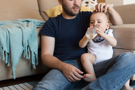 Modern father playing with little baby boyの写真素材