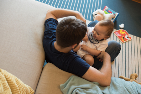 Modern father playing with little baby boyの写真素材