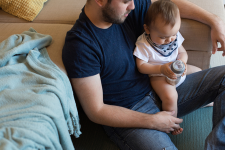 Modern father playing with little baby boyの写真素材