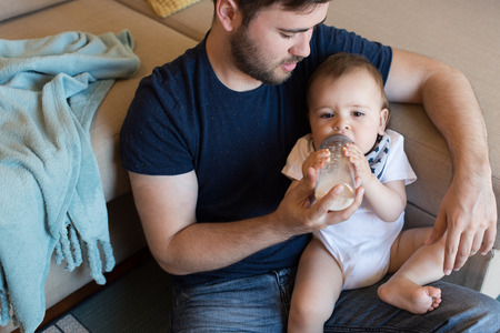 Modern father playing with little baby boyの写真素材