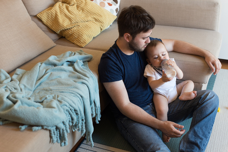 Modern father playing with little baby boyの写真素材