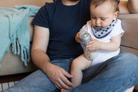Modern father playing with little baby boyの写真素材