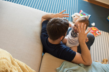 Modern father playing with little baby boyの写真素材