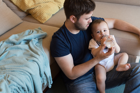 Modern father playing with little baby boyの写真素材
