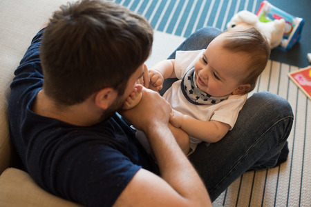 Modern father playing with little baby boyの写真素材