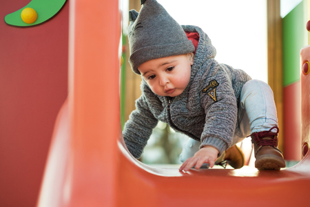 Little boy having fun on a toddler parkの写真素材