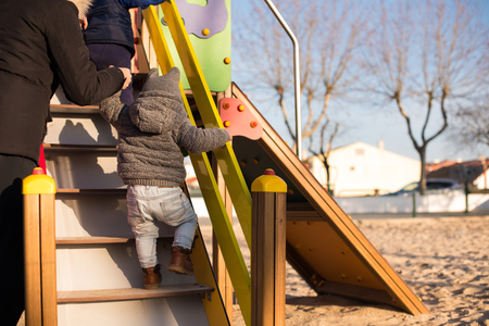 Little boy climbing stairs of a toddler parkの写真素材