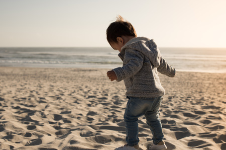 Toddler having great fun on the beachの写真素材