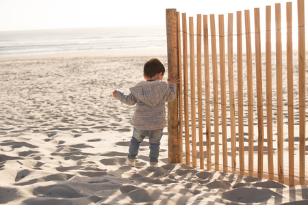 Toddler having great fun on the beachの写真素材