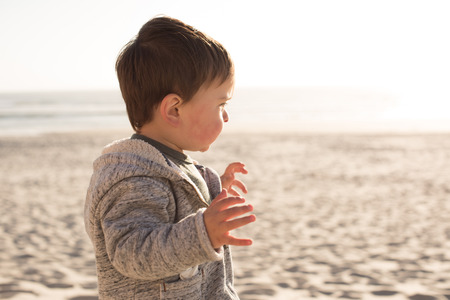 Toddler having great fun on the beachの写真素材