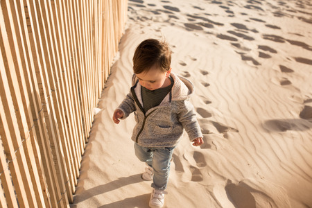 Toddler having great fun on the beachの写真素材