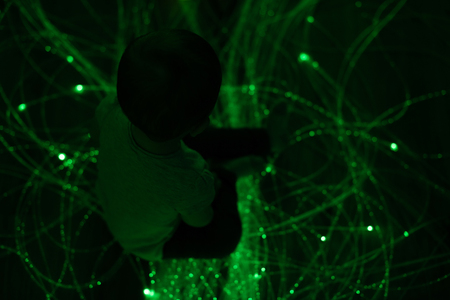 Young kid exploring a multi sensory space - snoezelen conceptの写真素材