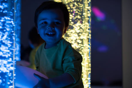 Young kid exploring a multi sensory space - snoezelen conceptの写真素材