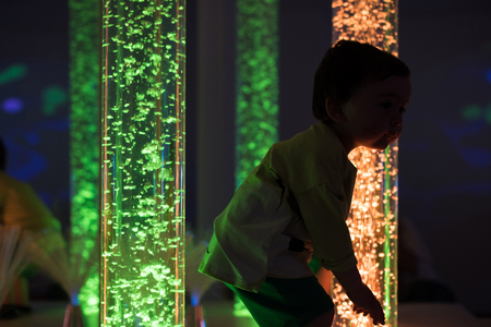 Young kid exploring a multi sensory space - snoezelen conceptの写真素材