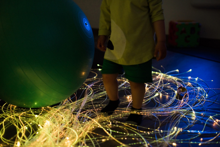 Young kid exploring a multi sensory space - snoezelen conceptの写真素材