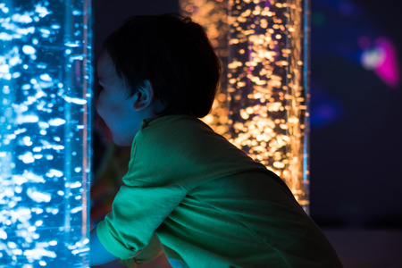 Young kid exploring a multi sensory space - snoezelen conceptの写真素材