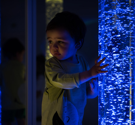 Young kid exploring a multi sensory space - snoezelen conceptの写真素材