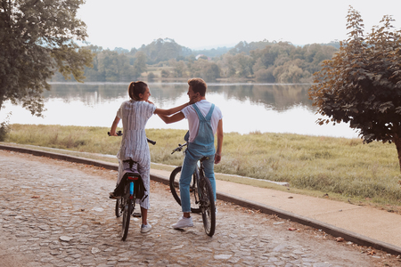 Romantic couple riding bicycles on a dateの写真素材