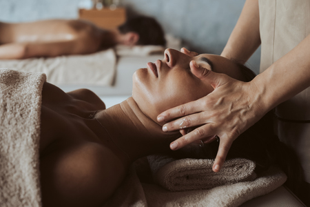 Woman enjoying a face, chest and sholders massage in Spaの写真素材