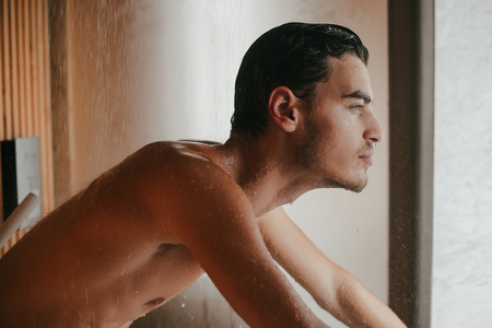 Sexy man naked and wet after bathの写真素材