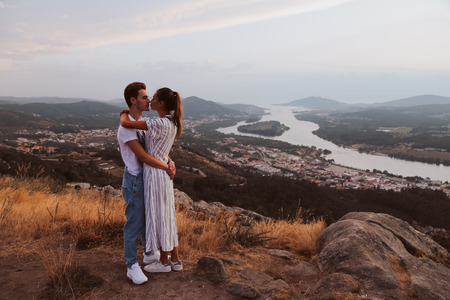 Romantic couple hugging and kissing with a fantastic viewの写真素材