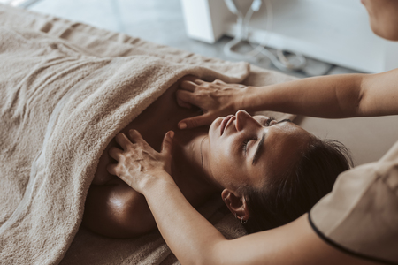 Woman having a facial massage at the spaの写真素材