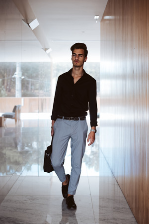 Casual business man walking inside office centerの写真素材