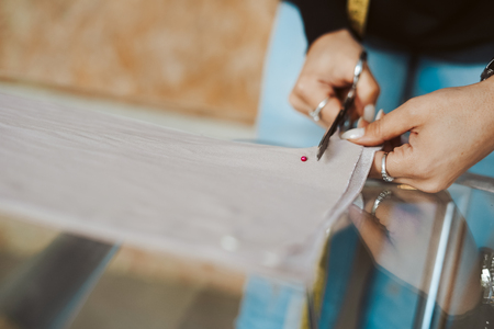 Tailor woman hands working on fabric - Tailoringの写真素材