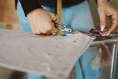 Tailor woman hands working on fabric - Tailoringの写真素材
