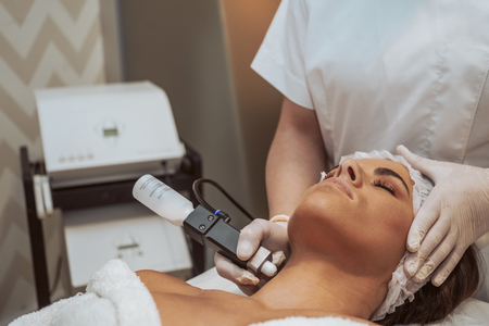 Woman getting cosmetic procedures at beauty center