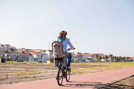 Eco-friendly Family.  Mother riding on a bicycle with young kid の写真素材