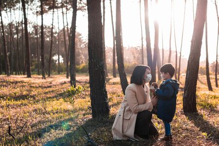 Mother and little kid using air protection masksの写真素材