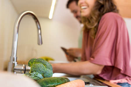Young couple chilling out while preparing the lunch