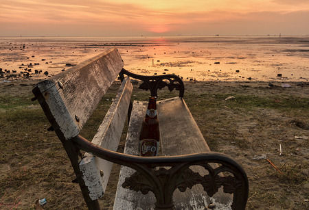 bench at sunrise beachの写真素材