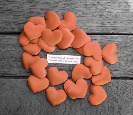 Loving relationship advice in a heap of love hearts on a wooden table topの写真素材